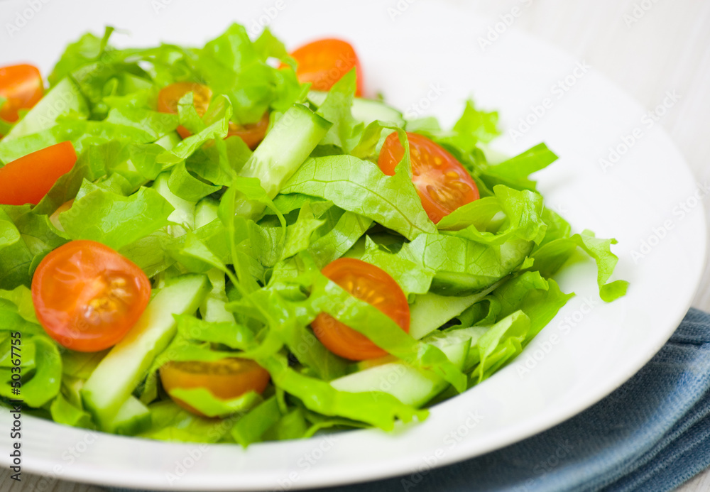 fresh vegetable salad with lettuce, tomato and cucumber
