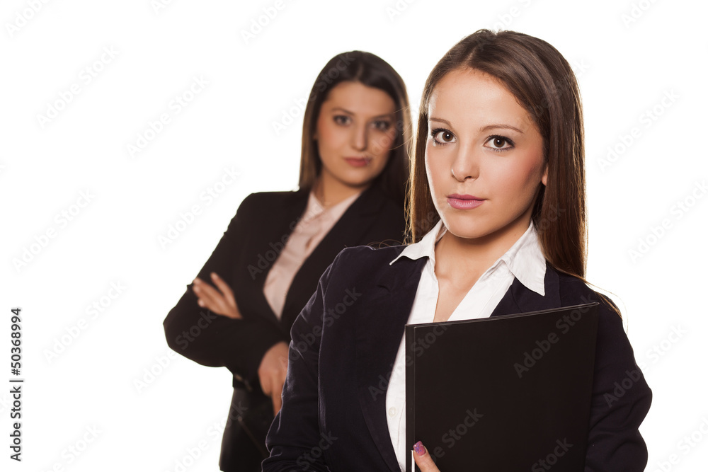 Two business women posing on white background Two business women posing on white background