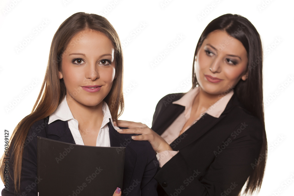 business woman holding a hand on the shoulder of her colleague business woman holding a hand on the shoulder of her colleague