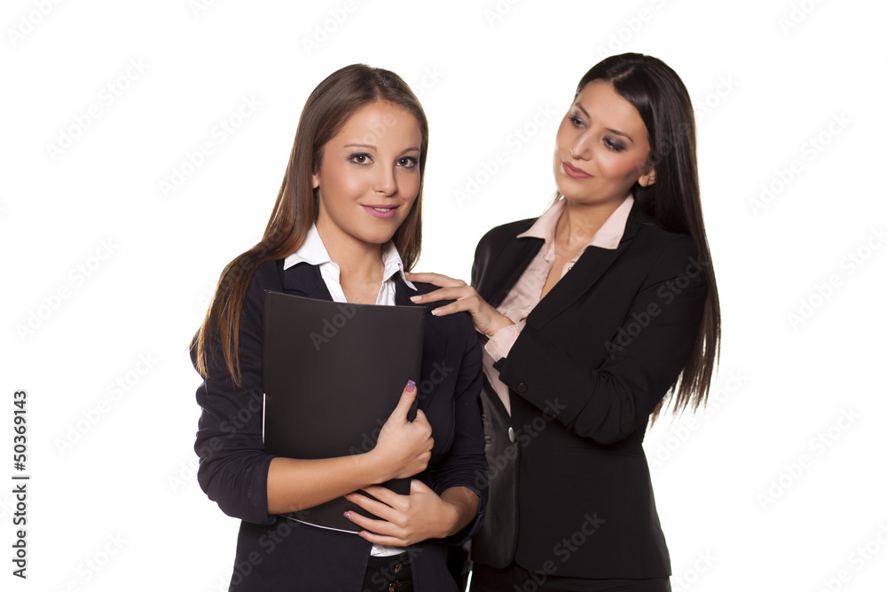 business woman holding a hand on the shoulder of her colleague business woman holding a hand on the shoulder of her colleague