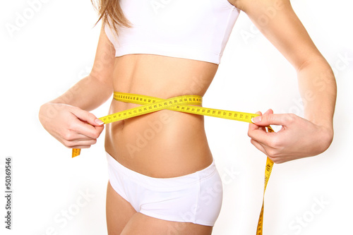 Closeup of young woman with measure tape on white background