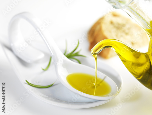 virgin olive oil pouring in a spoon