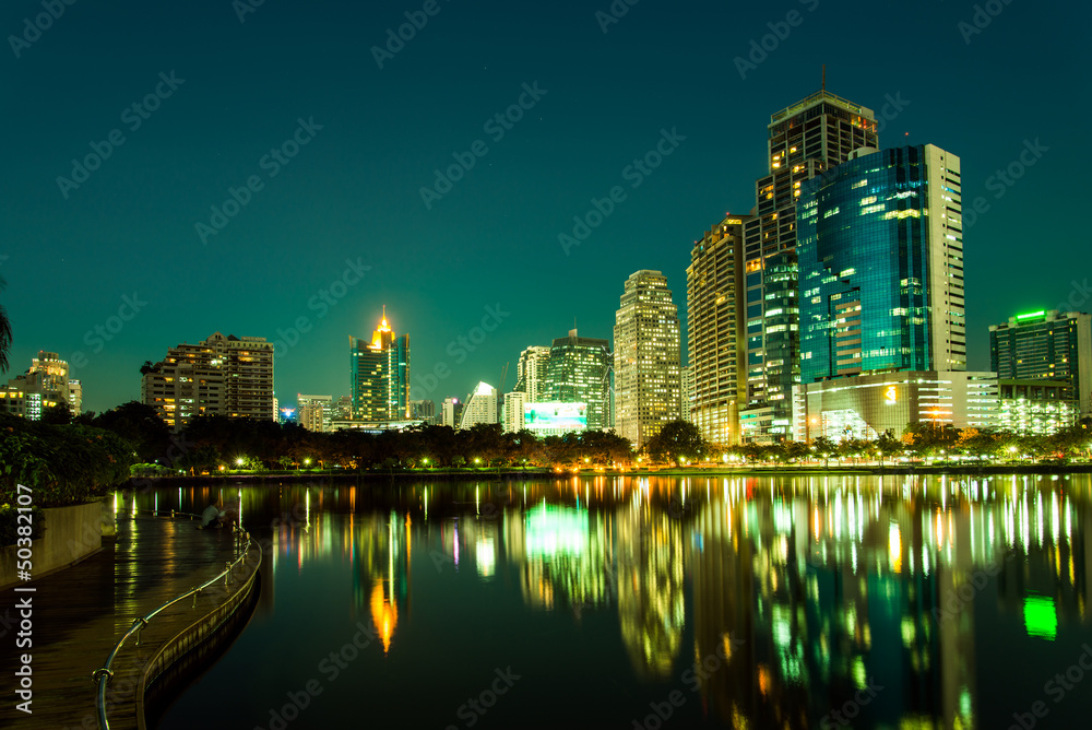 City downtown at night with reflection of skyline,Emerald green