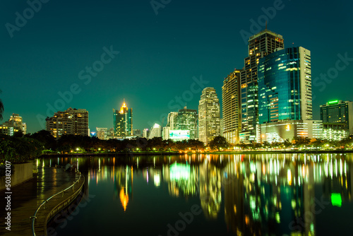 City downtown at night with reflection of skyline,Emerald green