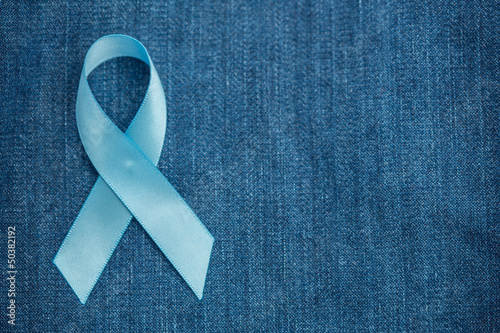 Blue ribbon for prostate cancer awareness on demin with copyspac photo