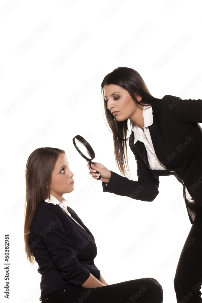 profesor staring at candidate over the magnifying glass profesor staring at candidate over the magnifying glass