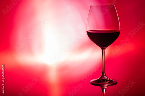 glass of wine on red