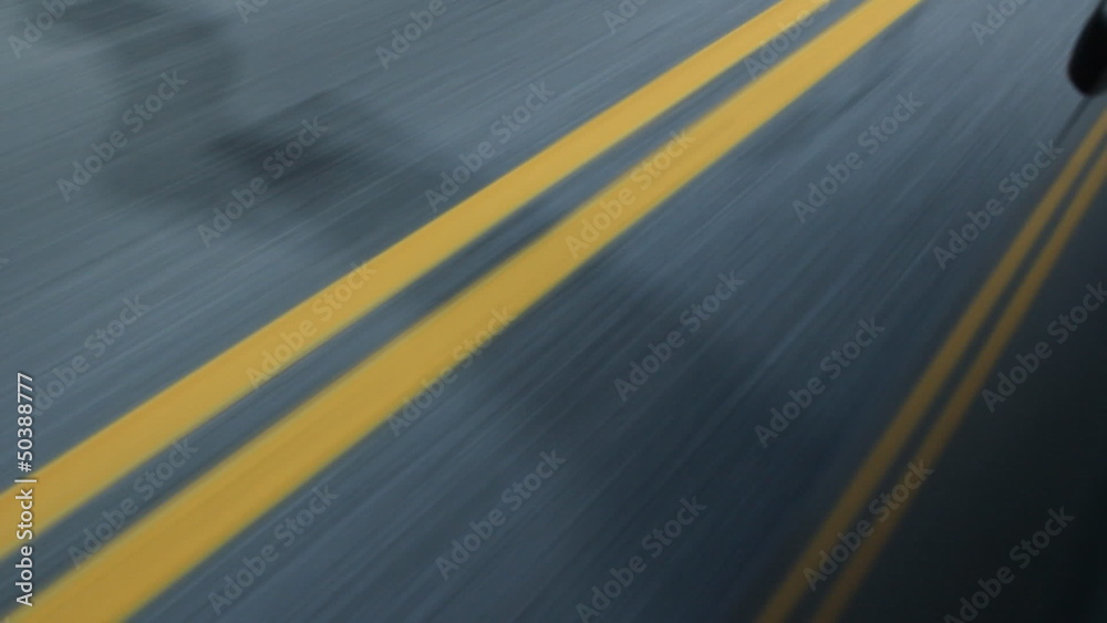 Double yellow lines on the road. Reflection in side of car.