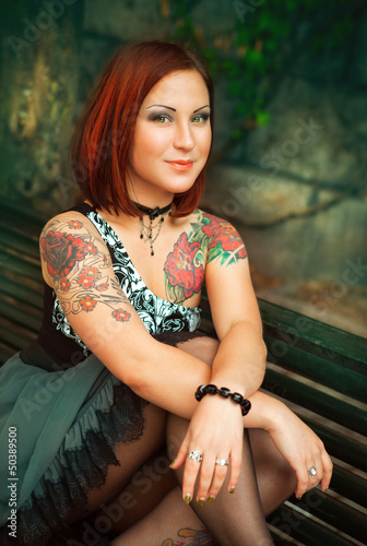 portrait of sexy woman with tattoo on her arms