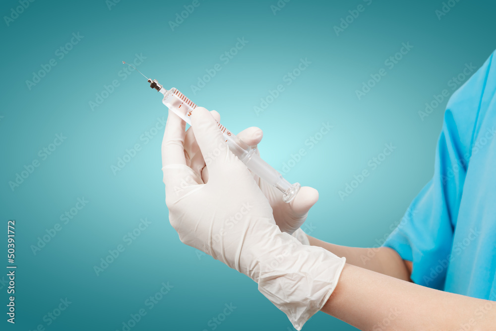 Doctor's hands holding syringe Doctor's hands holding syringe