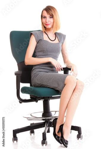 Full length business woman sitting on chair holding clipboard 