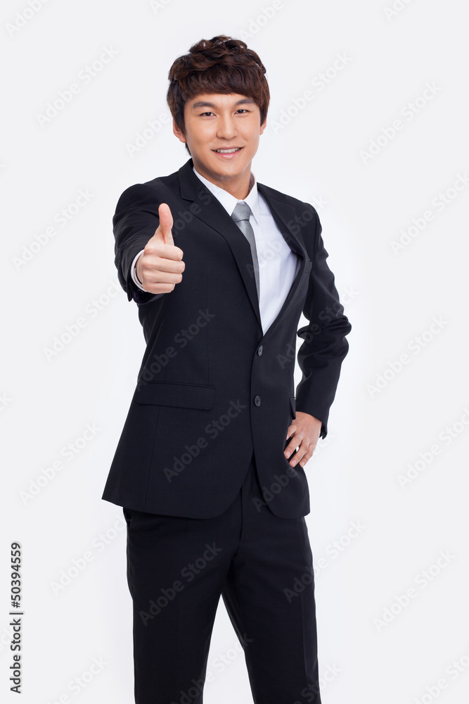Showing thumb young Asian business man.