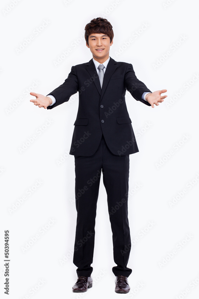 Young Asian business man showing welcom sign. Young Asian business man showing welcom sign.