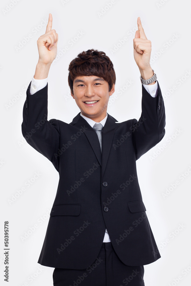Young asian man indicated up side. Young asian man indicated up side.
