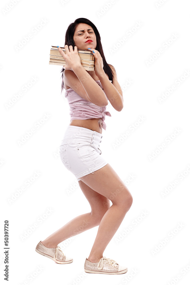 Fototapeta premium Latin schoolgirl trying to carry a heavy stack of books