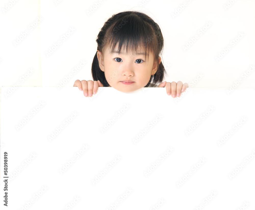 Asian little girl hiding behind white board Asian little girl hiding behind white board