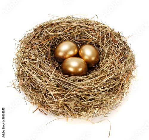 Three golden eggs in hay nest