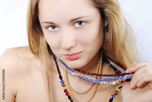 Portrait of the beautiful girl in costume jewellery