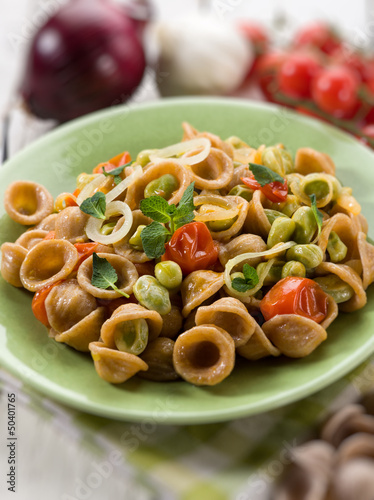 orecchiette with bean broad and fresh tomatoes, selective focus