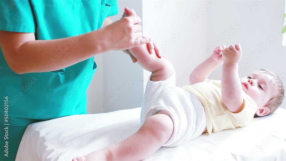 Physiotherapist massaging little baby boy foot Physiotherapist massaging little baby boy foot