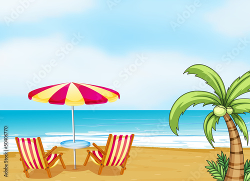 The beach with an umbrella and chairs
