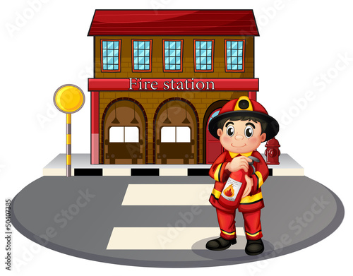 A fireman holding a fire extinguisher in front of the fire stati