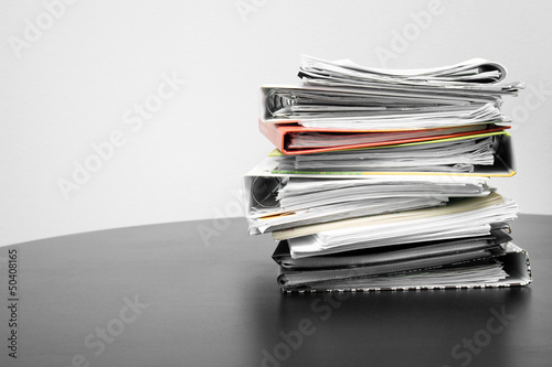 stack of folders and documents on office table