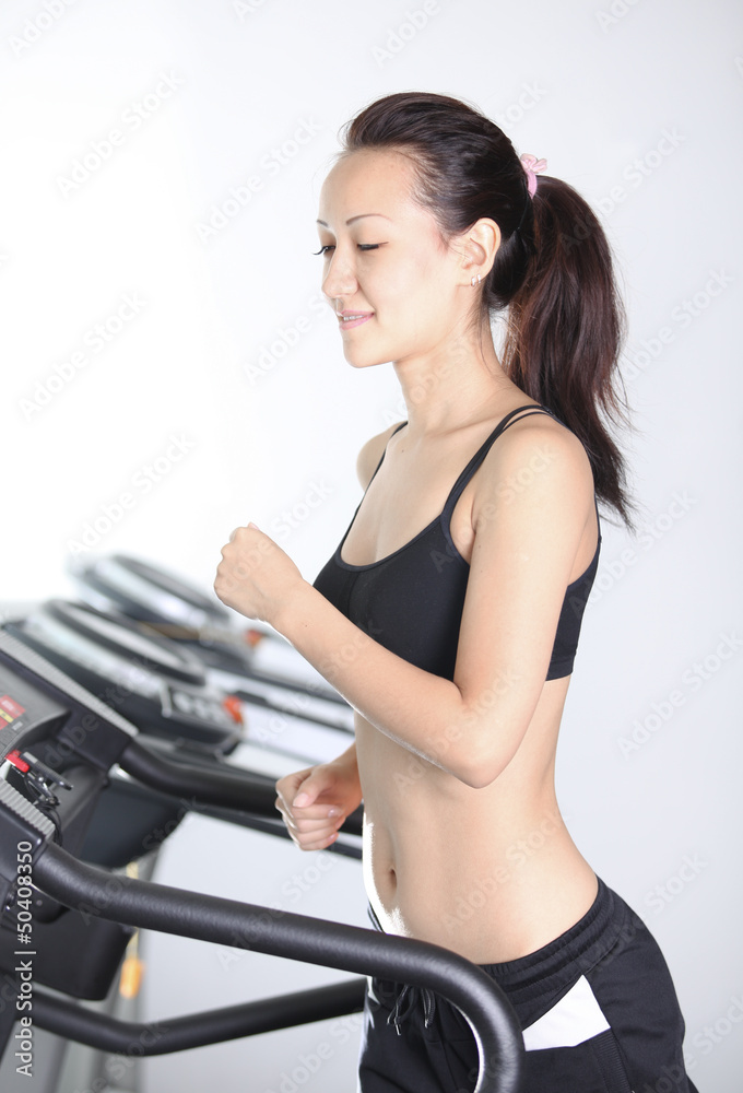 Asian girl slim body likes to run in the simulator