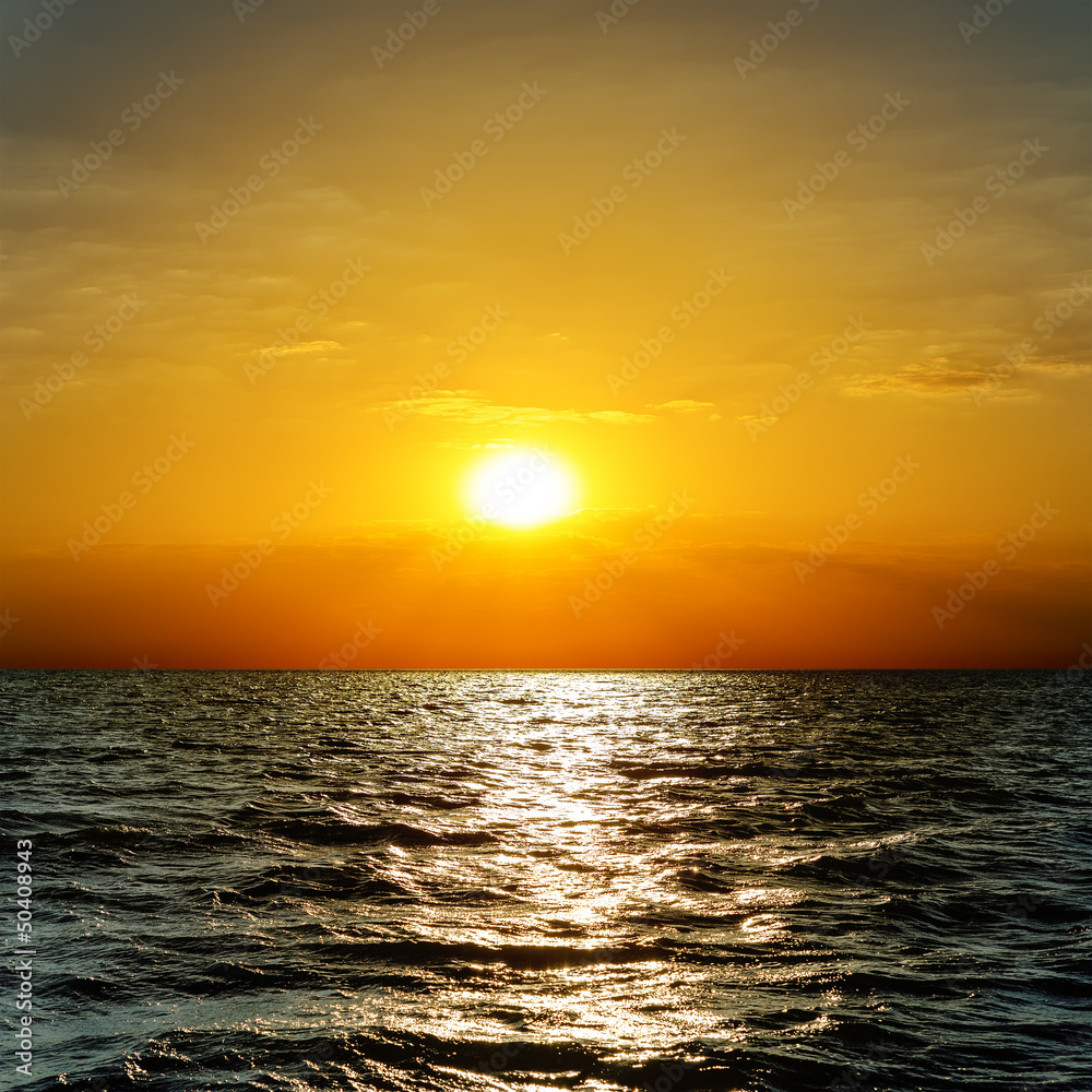 dramatic sunset over dark sea
