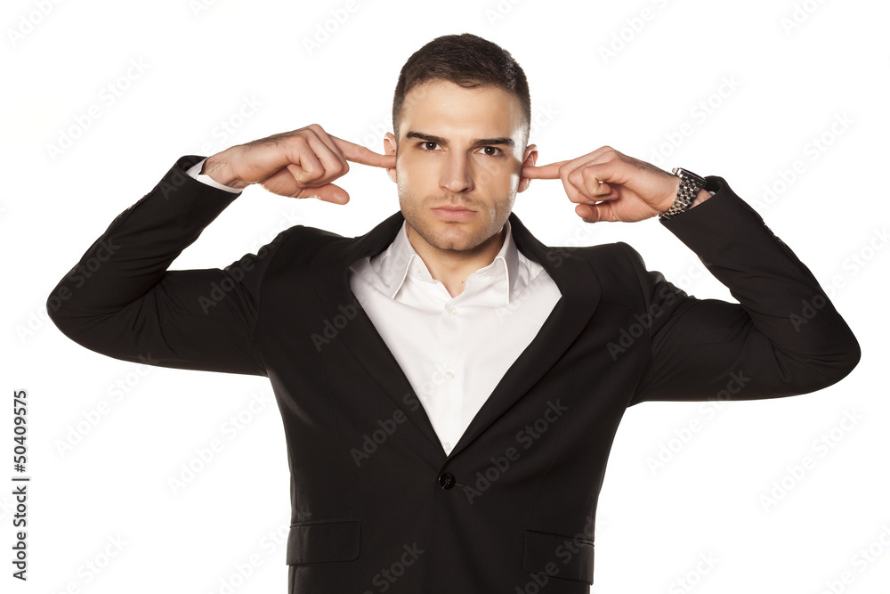businessman in black suit, clog his ears with fingers businessman in black suit, clog his ears with fingers