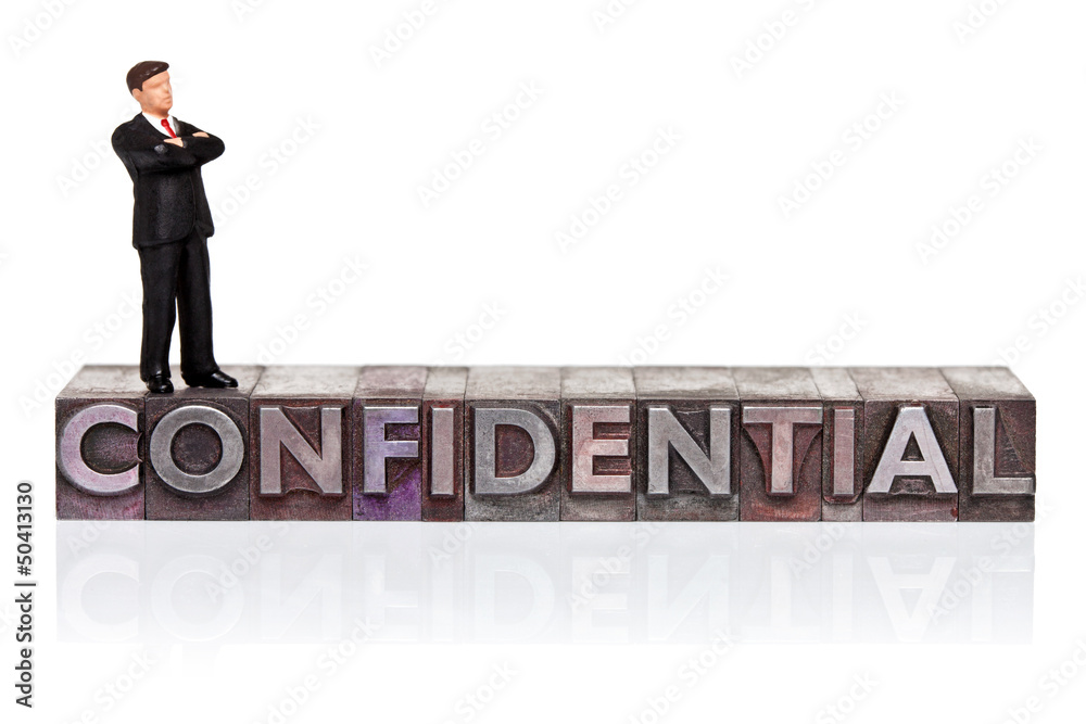 Confidential word in letterpress with miniature Confidential word in letterpress with miniature