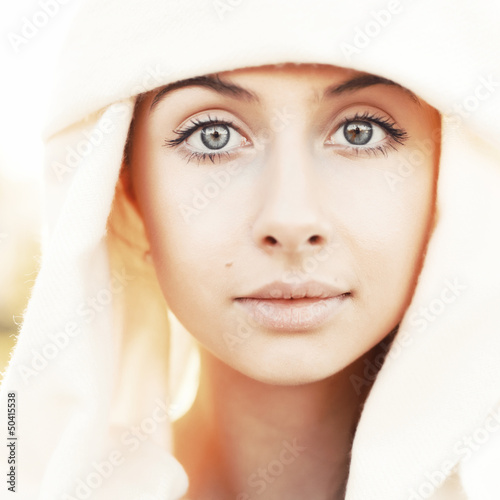 Portrait of calm beautiful young woman in head scarf close up