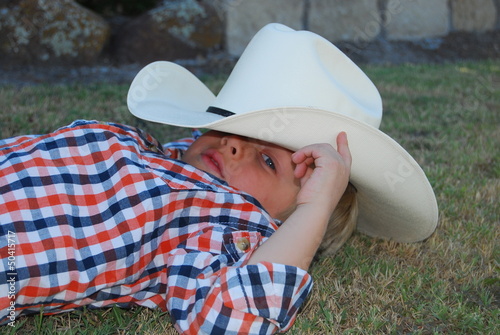Young cowboy relaxing