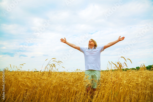 Young man staying with raised hands