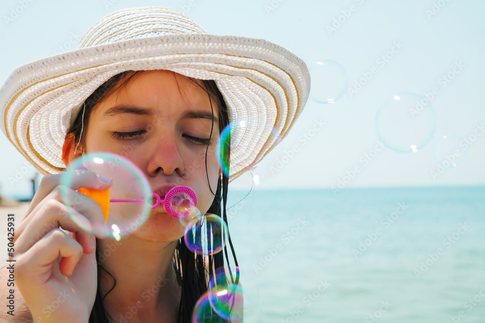 Teen girl blowing bubbles