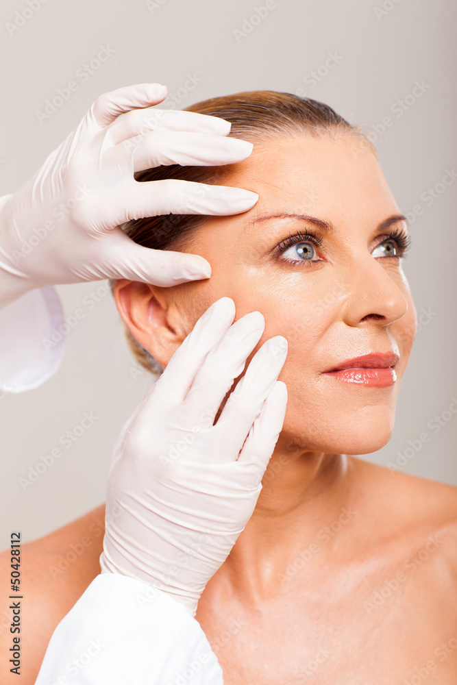 skin check on mid age woman face