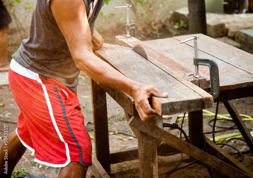 Man working on a saw.