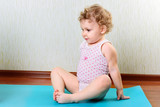 Cute little girl exercising in gym