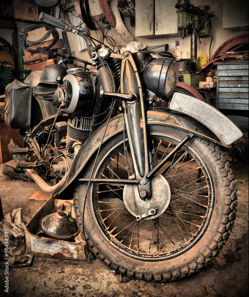 Naklejka premium HDR style old retro motorcycle in garage