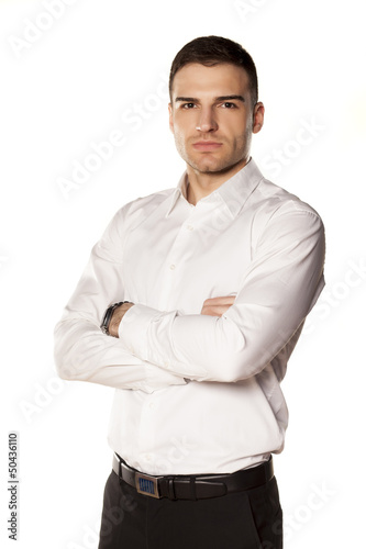 businessman smiling in a white shirt, with his hands crossed © vladimirfloyd