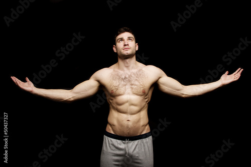 Topless man stood with his arms outstretched