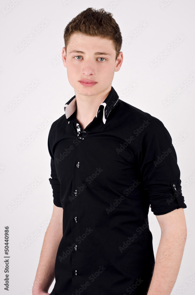 Fototapeta premium Young attractive stylish man in black shirt standing.