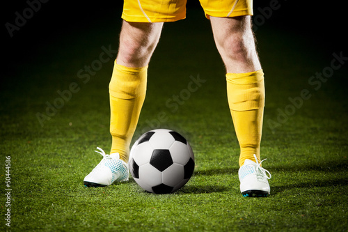 Close up of a soccer ball and a feet of a soccer player