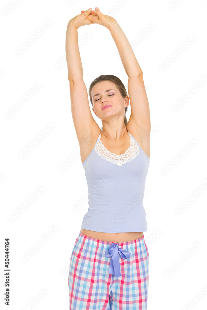 Young woman in pajamas stretching after sleep Young woman in pajamas stretching after sleep
