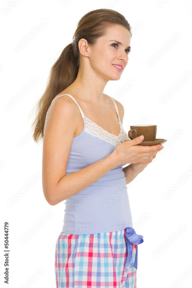 Young woman in pajamas with cup of coffee Young woman in pajamas with cup of coffee