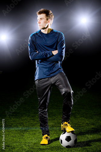 football player on grass field. Sport portrait. © Alexander Mak