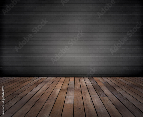 Raum: Graue Ziegelwand mit Holzfussboden