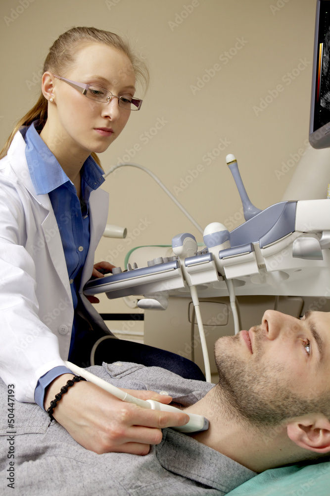 Fototapeta premium Portrait of young female technician operating ultrasound machine