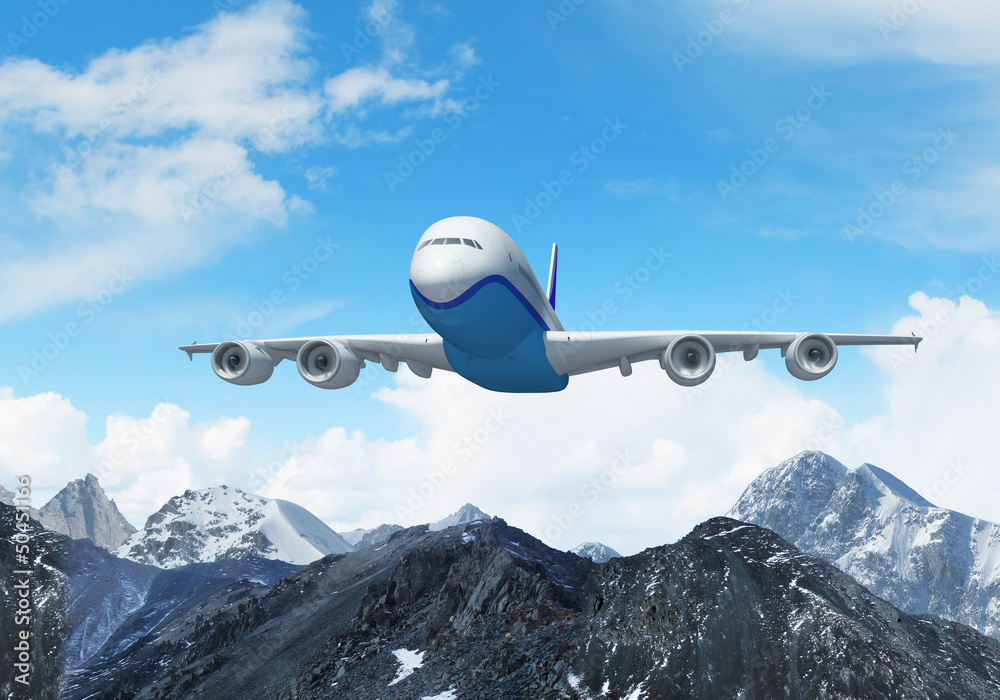 Fototapeta premium White passenger plane above the mountains