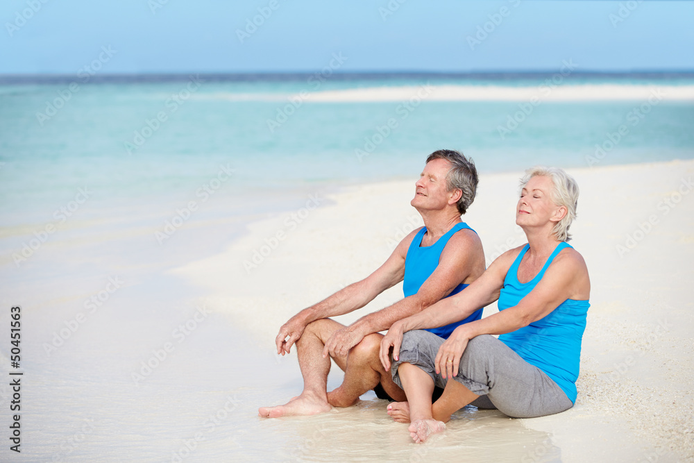 Senior Couple In Sports Clothing Relaxing On Beautiful Beach Senior Couple In Sports Clothing Relaxing On Beautiful Beach